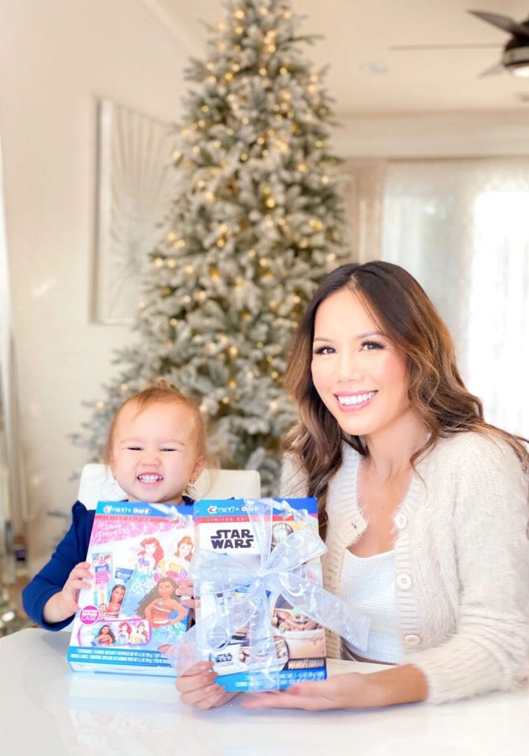 Rachel Vogt with her daughter holding Crest and Oral B Disney-themed products